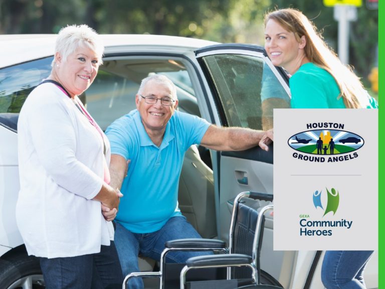Two women helping a man get out of a car